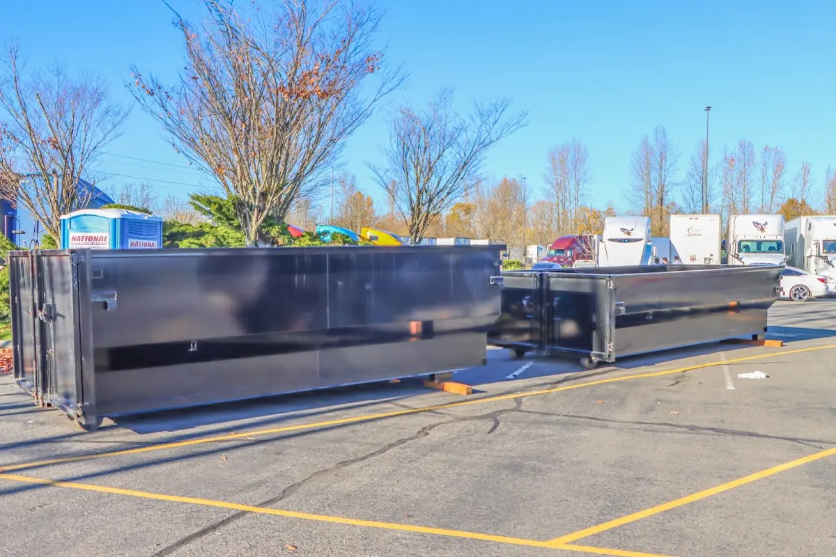 Professional dumpster rental service with roll-off container on residential driveway in Uxbridge